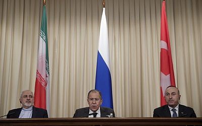 Iranian Foreign Minister Mohammad Javad Zarif, left, Russian Foreign Minister Sergey Lavrov, center, and Turkey's Foreign Minister Mevlut Cavusoglu, attend a joint news conference on December 20, 2016, after their talks in Moscow, Russia. (AP Photo/Pavel Golovkin, File)