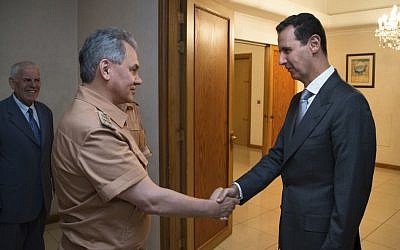  In this June 18, 2016 file photo, Syrian President Bashar Assad, right, shakes hands with Russian Defense Minister Sergei Shoigu in Damascus, Syria. (Vadim Savitsky/ Russian Defense Ministry Press Service pool photo via AP, File)