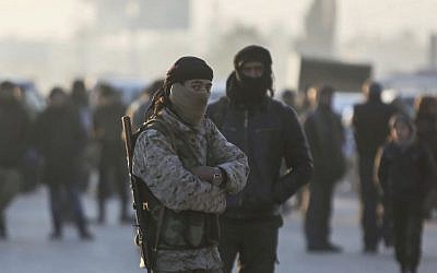 Armed Syrian fighters evacuated from the embattled Syrian city of Aleppo during a ceasefire arrive at a refugee camp in Rashidin, near Idlib, Syria, December 20, 2016. (AP)