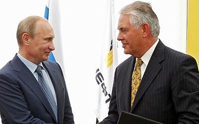 In this June 15, 2012, file photo, Russian President Vladimir Putin, left, and ExxonMobil CEO Rex Tillerson shake hands at a signing ceremony of an agreement between state-controlled Russian oil company Rosneft and ExxonMobil at the Black Sea port of Tuapse, southern Russia. (Mikhail Klimentyev/RIA-Novosti, Presidential Press Service via AP, Pool, File)