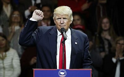 President-elect Donald Trump raises his fist as he speaks during the first stop of his post-election tour, Thursday, Dec. 1, 2016, in Cincinnati, Ohio. (AP Photo/John Minchillo)