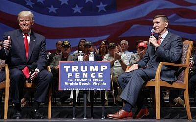 In this Sept. 6, 2016, file photo, then Republican presidential candidate Donald Trump gives a thumbs-up as he speaks with retired Lt. Gen. Michael Flynn during a town hall in Virginia Beach, Va. (AP Photo/Evan Vucci)