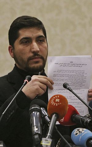 Osama Abu Zeid of the the main moderate Syrian opposition group Free Syrian Army, shows what he said is a copy of the five-point cease-fire agreement for Syria, during a news conference in Ankara, Turkey, Thursday, December 29, 2016. (AP/Burhan Ozbilici)