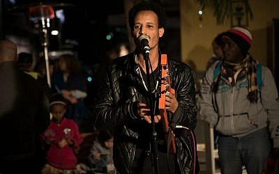 Bereket Tekle of the Yatana Band performs at the Nightlight Festival in the neighborhood of Neve Sha'anan in Tel Aviv, December 24, 2016. (Luke Tress/Times of Israel)
