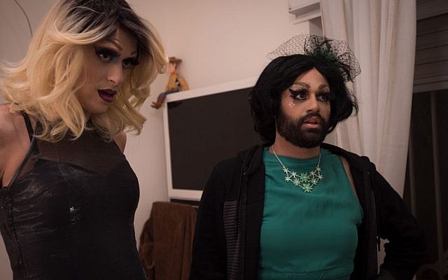 Israeli drag queens Yosale (left) and Noir Styrofoam (right) take a last look in the mirror before heading to a performance at the Videopub in Jerusalem. (Luke Tress/Times of Israel)