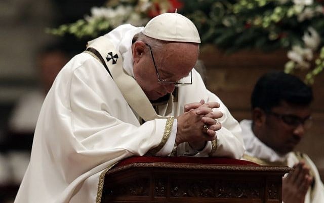 Pope Francis kneels as he celebrates the Christmas Eve Mass in St. Peter's Basilica at the Vatican, Saturday, Dec. 24, 2016. (AP Photo/Alessandra Tarantino) Pope Francis kneels as he celebrates the Christmas Eve Mass in St. Peter's Basilica at the Vatican, Saturday, Dec. 24, 2016. (AP Photo/Alessandra Tarantino)