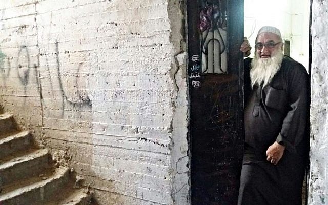 Mohammad Abdul-Aziz Mohammad al-Hussieni (62), stands near the entrance to his home in the Samoud "refugee camp," located near the Sheikh Jarrah neighborhood of Jerusalem, Israel. Photo taken on November 10, 2016. (Dov Lieber / Times of Israel)