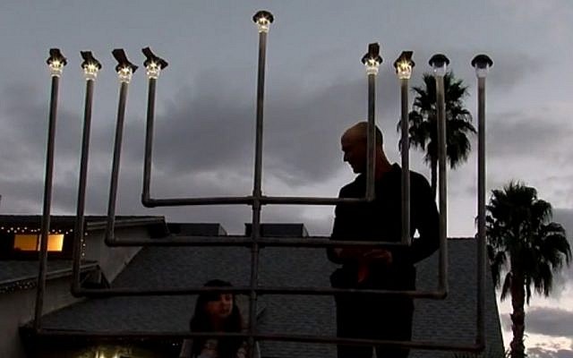 A restored menorah is relit outisde the Ellis family home in Chandler, Arizona, December 30, 2016 (ABC15 / YouTube screenshot) A restored menorah is relit outisde the Ellis family home in Chandler, Arizona, December 30, 2016 (ABC15 / YouTube screenshot)