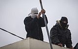 Jewish youths prepare to resist the evacuation of Amona in the West Bank on December 15, 2016, after the residents voted against a peaceful evacuation. (Yonatan Sindel/Flash90)