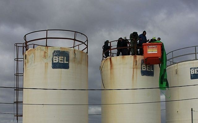 Protesters gather atop a water tower in Amona on December 15, 2016. (Judah Ari Gross/ Times of Israel)