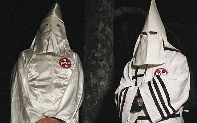 Two masked Ku Klux Klansmen stand on a muddy dirt road during an interview near Pelham, NC on Dec. 2, 2016. (AP Photo/Jay Reeves) Two masked Ku Klux Klansmen stand on a muddy dirt road during an interview near Pelham, NC on Dec. 2, 2016. (AP Photo/Jay Reeves)
