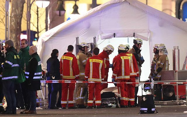 Rescue workers outside a tent in the area after a lorry truck plowed through a Christmas market in Berlin, Dec. 19, 2016. (Sean Gallup/Getty Images via JTA)