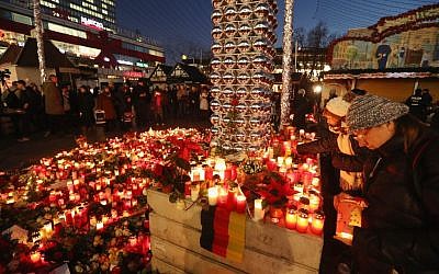 Mourners laying flowers and candles at a makeshift memorial in Berlin near the site where two days earlier, a man drove a heavy truck into a Christmas market in an apparent terrorist attack, Dec. 21, 2016. (Sean Gallup/Getty Images via JTA) Mourners laying flowers and candles at a makeshift memorial in Berlin near the site where two days earlier, a man drove a heavy truck into a Christmas market in an apparent terrorist attack, Dec. 21, 2016. (Sean Gallup/Getty Images via JTA)