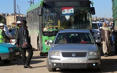 A bus is seen in the embattled city of Aleppo during an evacuation operation of rebel fighters and their families from rebel-held areas on December 15, 2016. 
 / AFP PHOTO / STRINGER