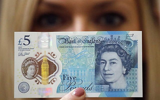 A Bank of England employee shows the new five pound note at the Bank of England Museum in London on Sept. 6, 2016. (AP Photo/Frank Augstein, File) A Bank of England employee shows the new five pound note at the Bank of England Museum in London on Sept. 6, 2016. (AP Photo/Frank Augstein, File)