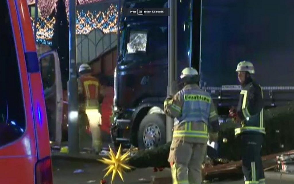 Firefighters around a truck after in crashed into a Berlin Christmas market on December 19, 2016. (screen capture: Fox News)