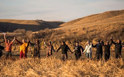 Standing Rock, North Dakota, November 26, 2016: Water Protectors gathered for a prayer circle as the sun set at the base of Turtle Island. (Getty images)