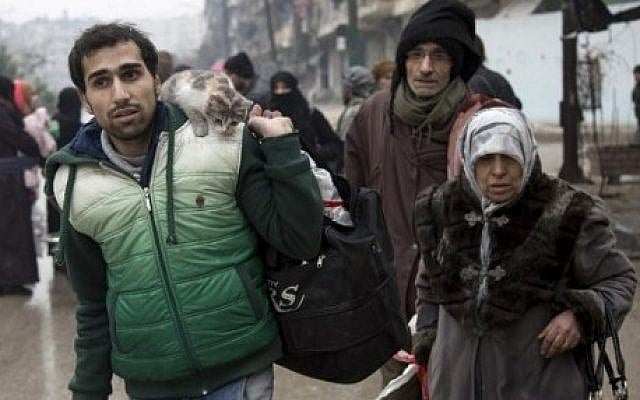 Syrians leave a rebel-held area of Aleppo for the government-held side on December 13, 2016, during an operation by Syrian government forces to retake the embattled city. (AFP PHOTO / KARAM AL-MASRI) Syrians leave a rebel-held area of Aleppo for the government-held side on December 13, 2016, during an operation by Syrian government forces to retake the embattled city. (AFP PHOTO / KARAM AL-MASRI)