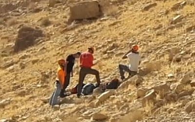 Rescue personnel attend the scene of an accident in Nahal Tze'elim in the Negev on December 9, 2016, in which a university lecturer and son died falling from a cliff (Arad Rescue Team via Channel 10)