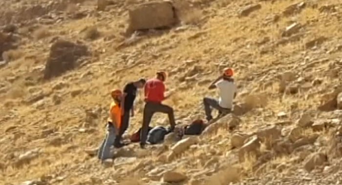 Rescue personnel at the scene of an accident in Nahal Tze'elim in the Negev on December 9, 2016, in which a university lecturer died trying to save his son as he fell from a cliff. (Arad Rescue Team via Channel 10) Rescue personnel at the scene of an accident in Nahal Tze'elim in the Negev on December 9, 2016, in which a university lecturer died trying to save his son as he fell from a cliff. (Arad Rescue Team via Channel 10)