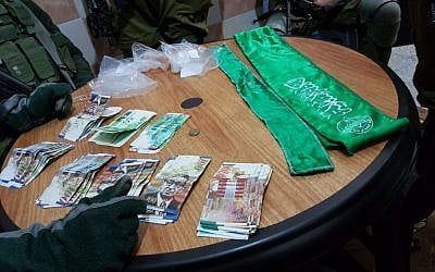 IDF troops seize thousands of shekels that were allegedly going to be used to fund terrorist activities on December 6, 2016. (IDF Spokesperson's Unit)
