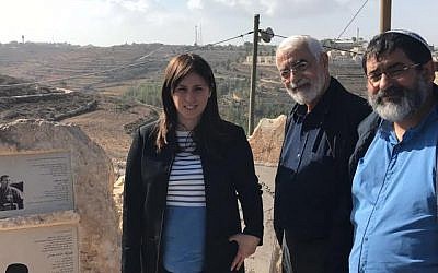 Deputy Foreign Minister Tzipi Hotovely with the father and brother of Emmanuel Moreno at the memorial site in the Netiv HaAvot outpost in the Eztion Bloc. December 6, 2016. (Courtesy of Tzipi Hotolevy's spokeswoman) 