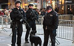 New York City police officers stand guard in Times Square on December 31, 2016. (Angela Weiss/AFP)