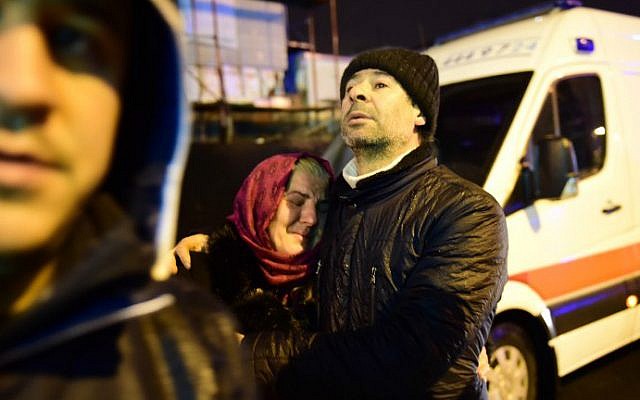 People react at the site of a shooting rampage in an Istanbul nightclub early on January 1, 2017. (Yasin Akgul/AFP)