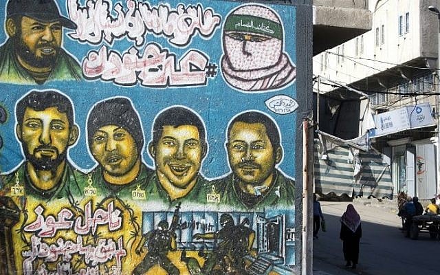 Graffiti depicting portraits of what is believed to be Israeli soldiers painted on a wall in Gaza City on January 1, 2017. The writing in Arabic reads: ''Nahel Oz, we left no soldiers in it...." (AFP PHOTO / MAHMUD HAMS)