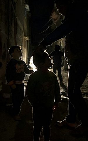 Palestinian children play on a street during a power cut in the Al-Shati refugee camp in Gaza City, on January 4, 2017. (AFP PHOTO / MAHMUD HAMS)