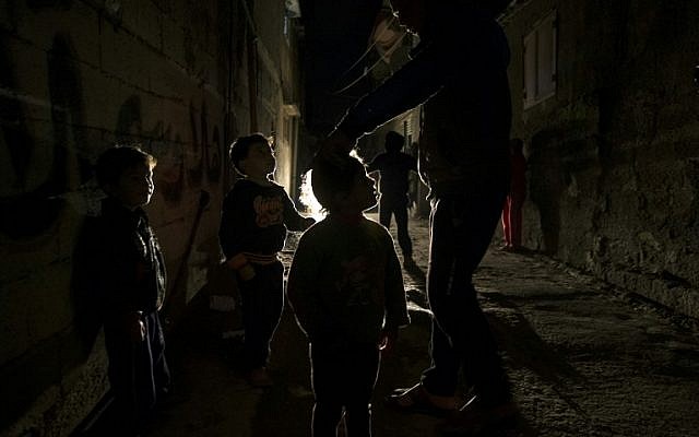 Palestinian children play on a street during a power cut in the Al-Shati refugee camp in Gaza City, on January 4, 2017. (AFP PHOTO / MAHMUD HAMS) Palestinian children play on a street during a power cut in the Al-Shati refugee camp in Gaza City, on January 4, 2017. (AFP PHOTO / MAHMUD HAMS)