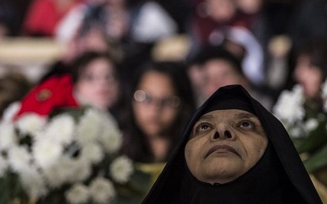 A nun attends Christmas mass led by Egyptian Coptic leader Pope Tawadros II at the St. Mark's Coptic Orthodox Cathedral in the Abbassia District of Cairo on January 6, 2017. (AFP PHOTO / KHALED DESOUKI) A nun attends Christmas mass led by Egyptian Coptic leader Pope Tawadros II at the St. Mark's Coptic Orthodox Cathedral in the Abbassia District of Cairo on January 6, 2017. (AFP PHOTO / KHALED DESOUKI)