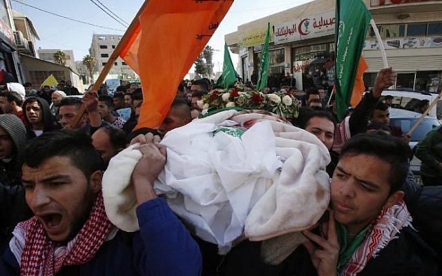 Mourners attend the funeral of Mohammed Rajabi, a Palestinian who was killed after carrying out a stabbing attack against Israeli soldiers months ago, in the West Bank town of Hebron on January 7, 2017, after his body was returned by Israeli authorities. (AFP/Hazem Bader) Mourners attend the funeral of Mohammed Rajabi, a Palestinian who was killed after carrying out a stabbing attack against Israeli soldiers months ago, in the West Bank town of Hebron on January 7, 2017, after his body was returned by Israeli authorities. (AFP/Hazem Bader)