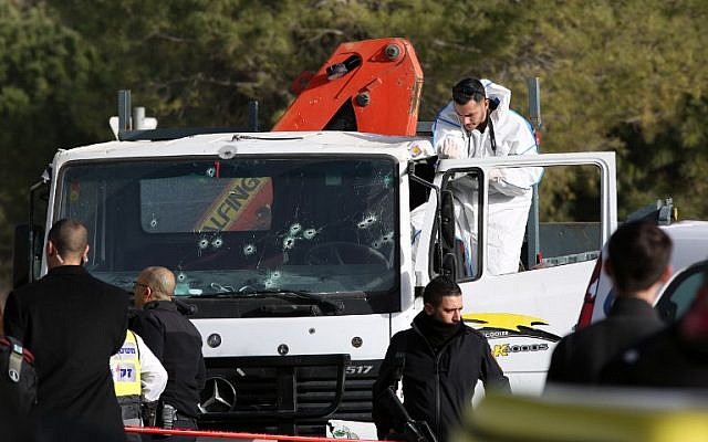 An Israeli forensics expert gathers evidence as security forces and emergency personnel gather at the site of a vehicle-ramming attack in Jerusalem on January 8, 2017. (AFP/ MENAHEM KAHANA) An Israeli forensics expert gathers evidence as security forces and emergency personnel gather at the site of a vehicle-ramming attack in Jerusalem on January 8, 2017. (AFP/ MENAHEM KAHANA)