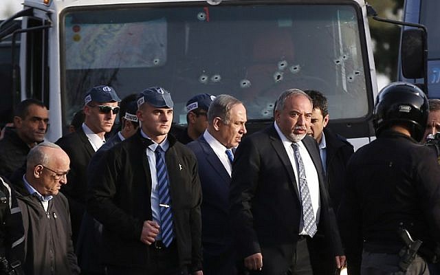Prime Minister Benjamin Netanyahu, center, and Defense Minister Avigdor Lieberman, to his left, visit the site of a vehicle-ramming attack in Jerusalem on January 8, 2017. (AFP/AHMAD GHARABLI) Prime Minister Benjamin Netanyahu, center, and Defense Minister Avigdor Lieberman, to his left, visit the site of a vehicle-ramming attack in Jerusalem on January 8, 2017. (AFP/AHMAD GHARABLI)