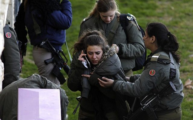 An Israeli soldier comforts a comrade near the site of a vehicle-ramming terror attack in Jerusalem, in which four soldiers were killed and 16 injured on January 8, 2017. (AFP PHOTO / MENAHEM KAHANA) An Israeli soldier comforts a comrade near the site of a vehicle-ramming terror attack in Jerusalem, in which four soldiers were killed and 16 injured on January 8, 2017. (AFP PHOTO / MENAHEM KAHANA)