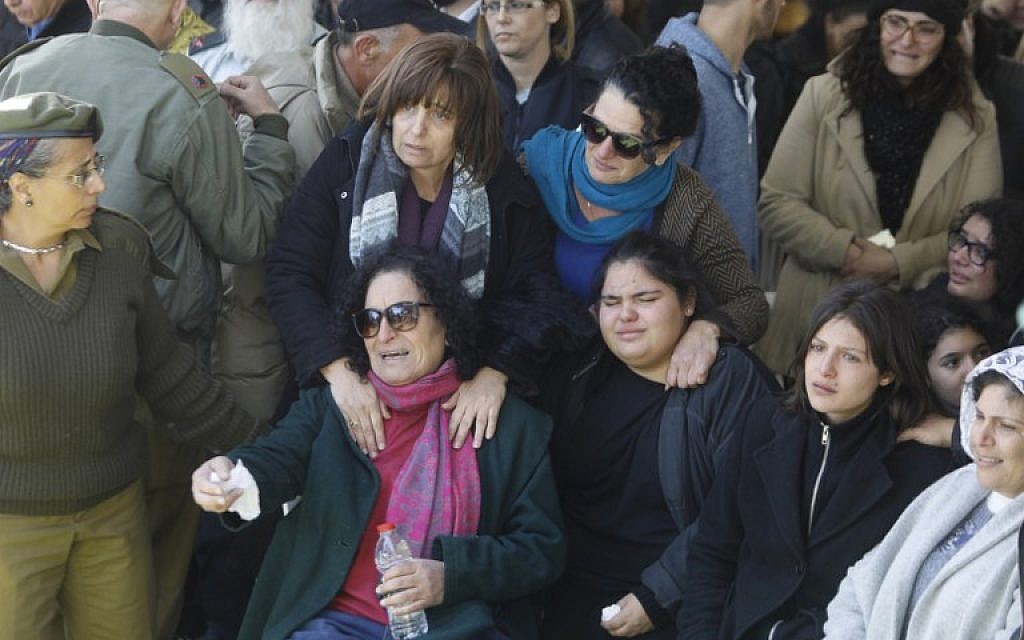 Relatives mourn during the funeral of Israeli soldier Shir Hajaj, 22, at the military cemetery on Mount Herzl in Jerusalem on January 9, 2016, a day after she was killed by a Palestinian terrorist when he rammed his vehicle into a group of Israeli soldiers. (Menahem Kahana/AFP)