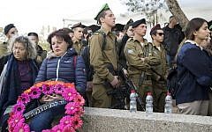 Friends and relatives of soldier Yael Yekutiel, who was killed a day earlier, mourn in front of her grave during her funeral at the Israeli Kiryat Shaul military cemetery in Tel Aviv, Israel on January 9, 2017. AFP/JACK GUEZ)