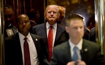 President-elect Donald Trump arrives from the elevator at Trump Tower January 9, 2017 in New York. (AFP Photo/Timothy A. Clary)