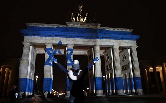 A woman strikes a pose in front of the Brandenburg Gate with the Israeli flag projected onto in Berlin, on January 9, 2017 to pay tribute to the victims of the ramming attack in Jerusalem. (AFP PHOTO / Odd ANDERSEN) A woman strikes a pose in front of the Brandenburg Gate with the Israeli flag projected onto in Berlin, on January 9, 2017 to pay tribute to the victims of the ramming attack in Jerusalem. (AFP PHOTO / Odd ANDERSEN)