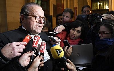 Herve Temime (L), the lawyer of Franco-American art-dealer Guy Wildenstein speaks to journalists on January 12, 2017 at the Paris court house, after the presiding judge cleared the art-dealer of hiding millions of euros in paintings and properties from the taxman. (AFP Photo/Lionel Bonaventure)
