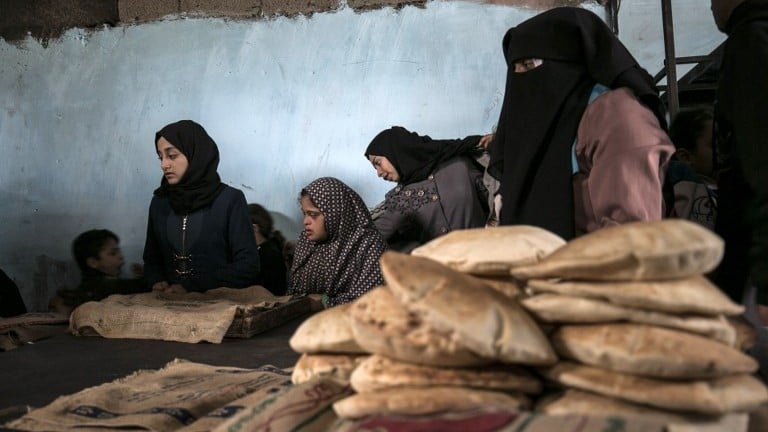 Palestinians collect freshly-baked bread at a traditional wood oven in the Rafah refugee camp, in the southern Gaza Strip on January 14, 2017. (AFP Photo/Said Khatib) Palestinians collect freshly-baked bread at a traditional wood oven in the Rafah refugee camp, in the southern Gaza Strip on January 14, 2017. (AFP Photo/Said Khatib)
