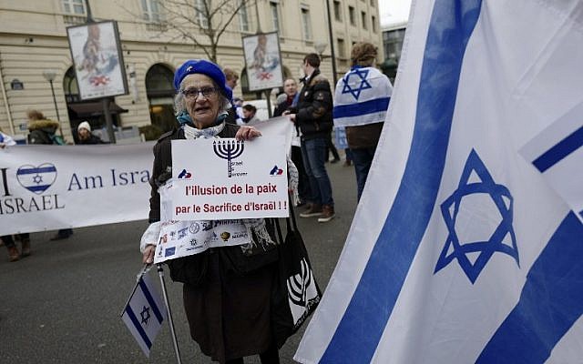A woman holds a sign reading "The illusion of peace by the sacrifice of Israel" during a protest rally against the Paris Middle East peace conference, January 15, 2017. (AFP/Pierre CONSTANT) A woman holds a sign reading "The illusion of peace by the sacrifice of Israel" during a protest rally against the Paris Middle East peace conference, January 15, 2017. (AFP/Pierre CONSTANT)