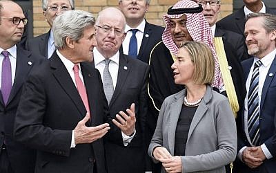 US Secretary of State John Kerry (L) speaks with European Union Foreign Policy Chief Federica Mogherini (R) as they take part with other foreign ministers and representatives in a Mideast peace conference in Paris on January 15, 2017. (AFP PHOTO / POOL / bertrand GUAY)