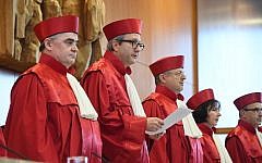 The President of Germany's Constitutional Court Andreas Vosskuhle, second left, is flanked by judges of the court's Second Senate as he reads the verdict rejecting a ban of Germany's right-extremist NPD party at the Federal Constitutional Court in Karlsruhe, southwestern Germany, on January 17, 2017. (AFP/POOL/Uli Deck)