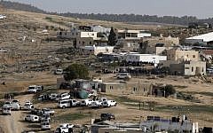 Israeli police (foreground) gather in the unreocgnized Bedouin village of Umm al-Hiran in the Negev desert. (AFP Photo/Menahem Kahana)
