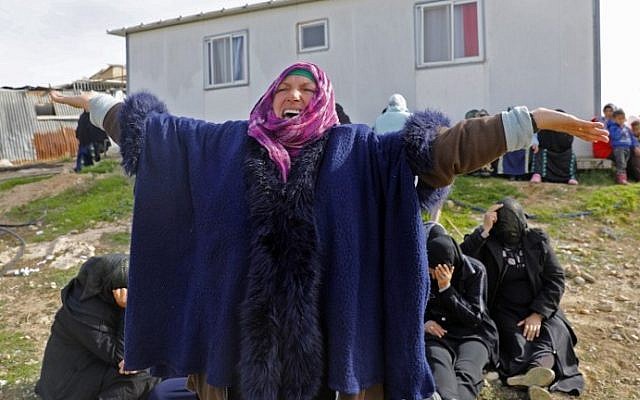 A Bedouin woman reacts during a protest against home demolitions on January 18, 2017 in the unrecognized Bedouin village of Umm al-Hiran in the Negev desert. (AFP Photo/Menahem Kahana)