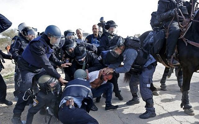 Israeli policemen detain a Bedouin man during a protest against home demolitions on January 18, 2017, in the unrecognized Bedouin village of Umm al-Hiran in the Negev desert. (AFP Photo/Ahmad Gharabli) Israeli policemen detain a Bedouin man during a protest against home demolitions on January 18, 2017, in the unrecognized Bedouin village of Umm al-Hiran in the Negev desert. (AFP Photo/Ahmad Gharabli)