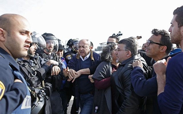 Israeli-Arab MKs Ahmad al-Tibi (C) and Yousef Jabareen (3rd-R) confront Israeli policemen during a demonstration in the unrecognized Bedouin village of Umm al-Hiran in the Negev desert,  on January 18, 2017. (AFP Photo/Ahmad Gharabli)