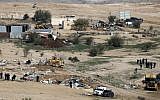 Israeli policemen stand guard as bulldozers demolish homes in the unrecognized Bedouin village of Umm al-Hiran in the Negev desert, on January 18, 2017. (AFP Photo/Menahem Kahana)
